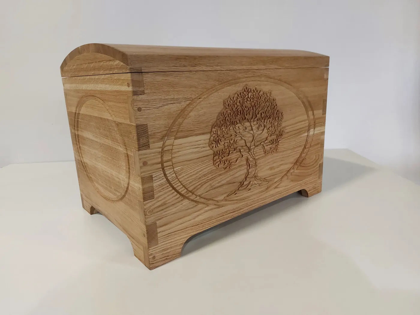 Tree-of-life oak chest, three-quarter view