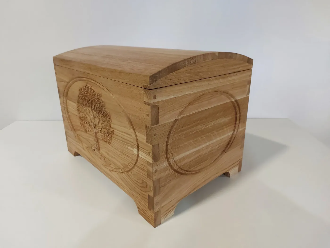 The tree-of-life chest from the left, carved front and dovetailed corners