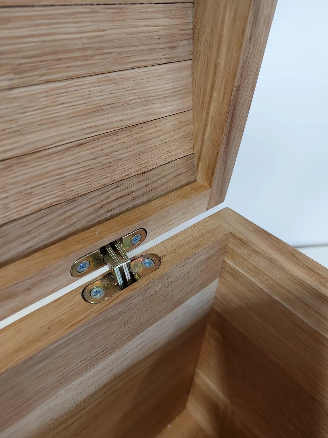 The hinge and the inside of the oak lid