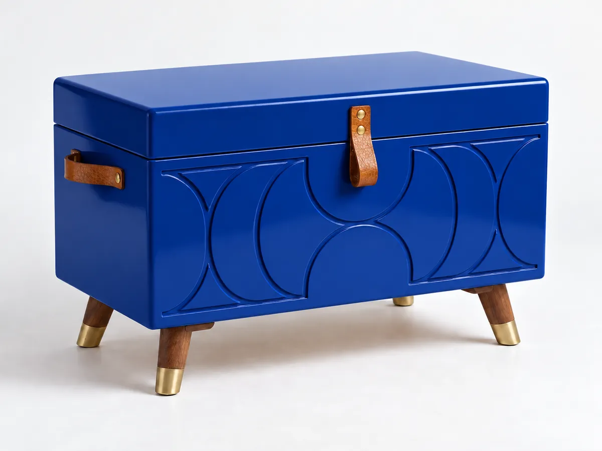 Deep blue painted chest with a routed arch pattern, tan leather pull and splayed brass-tipped legs — AI concept