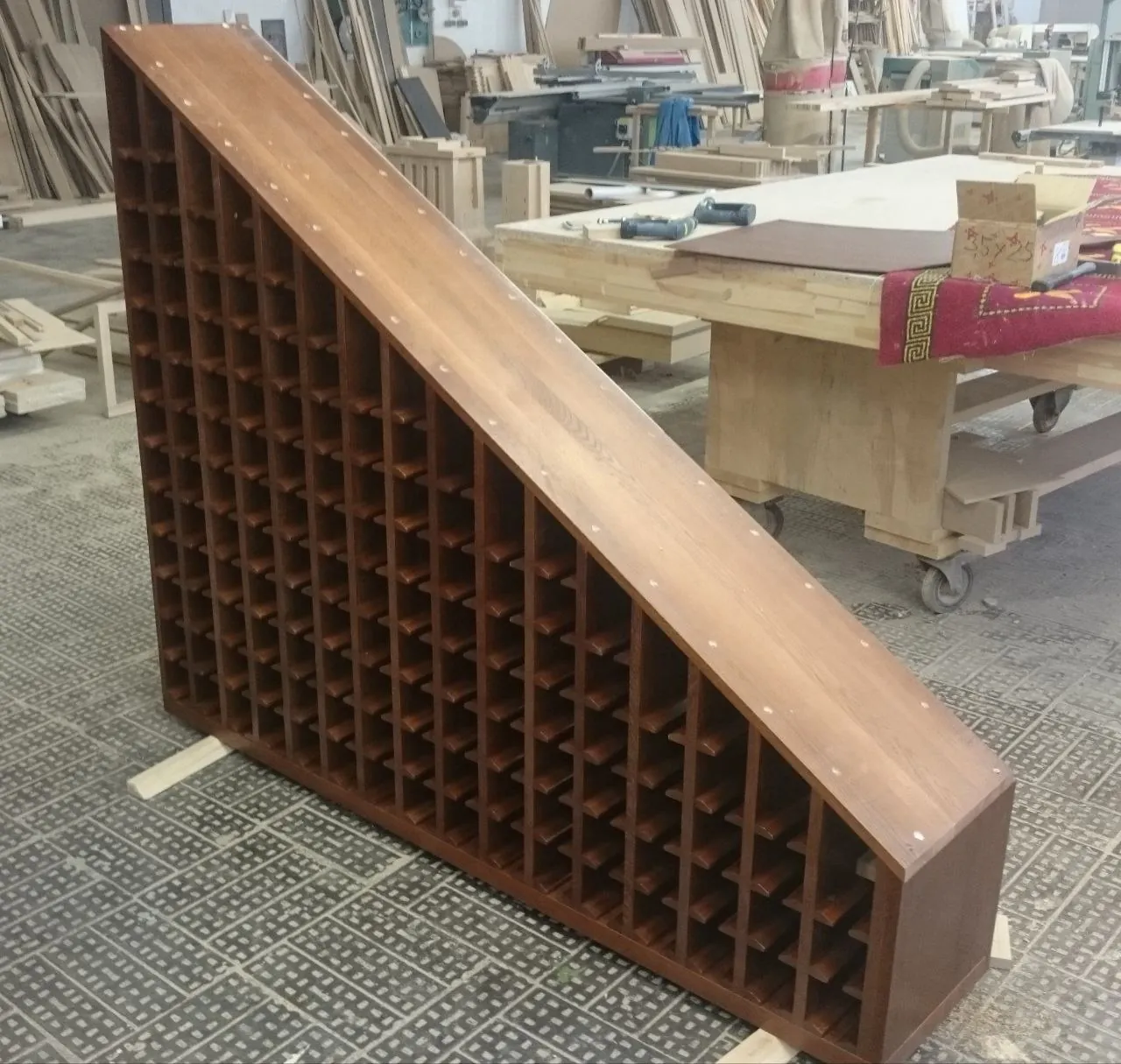 Under-stair wine rack, finished and stained, in the workshop