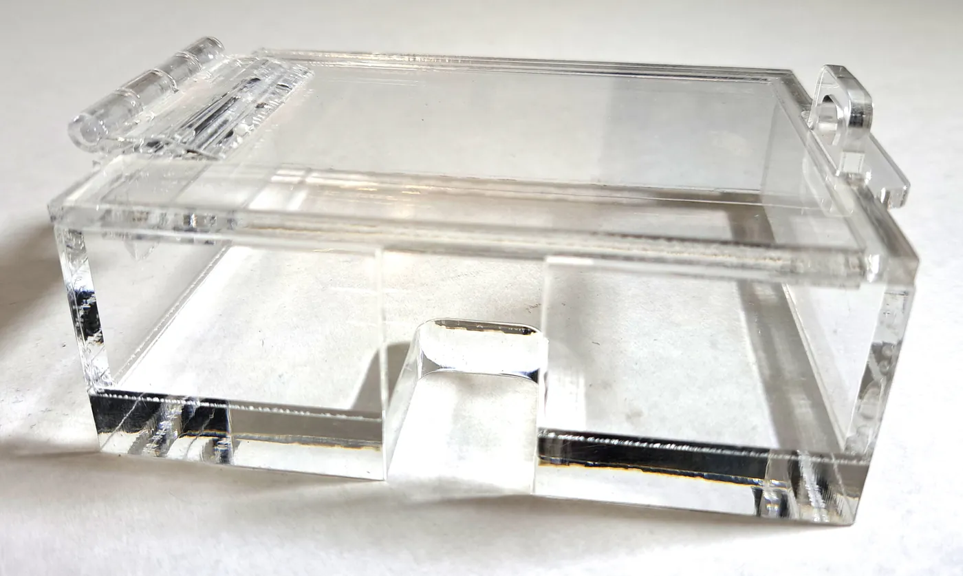 Small clear acrylic box with a hinged lid and a finger notch