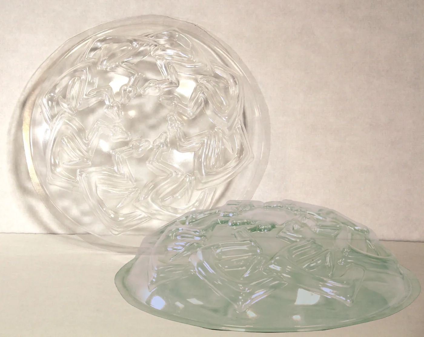 Two clear plastic domes with a raised pattern