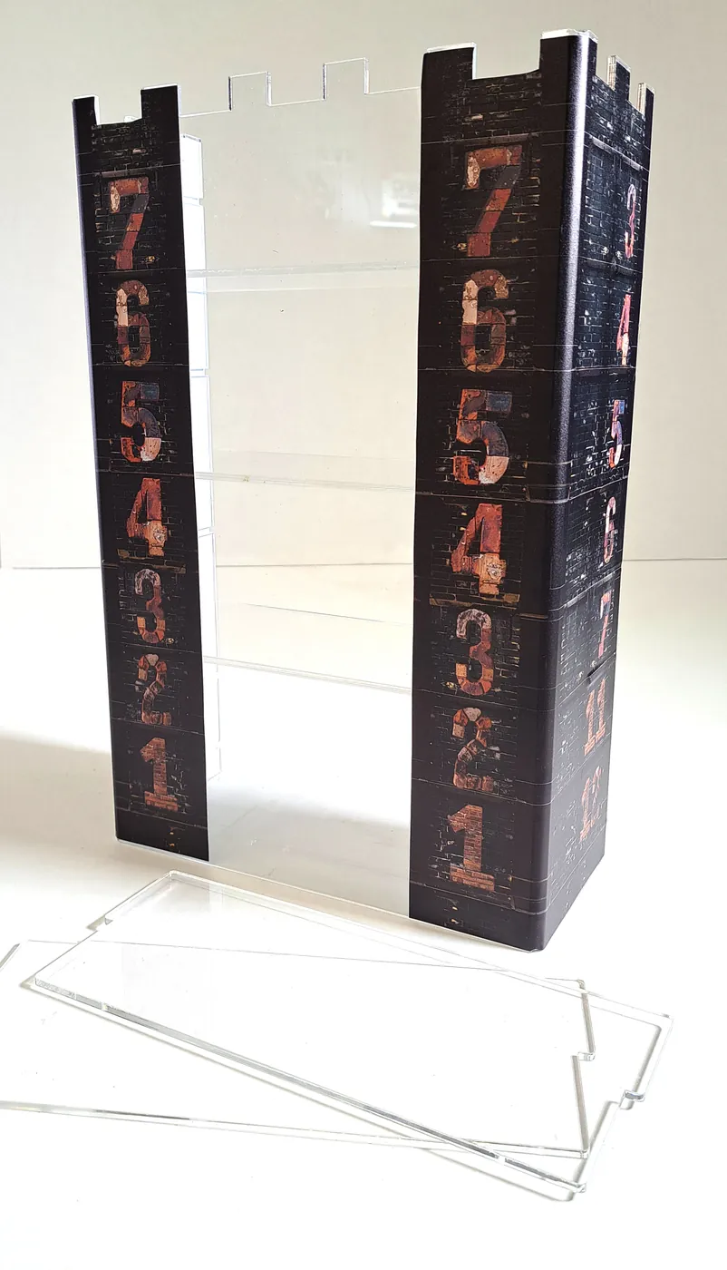 Castle-shaped tower with two printed columns numbered from one to seven and loose clear acrylic shelves