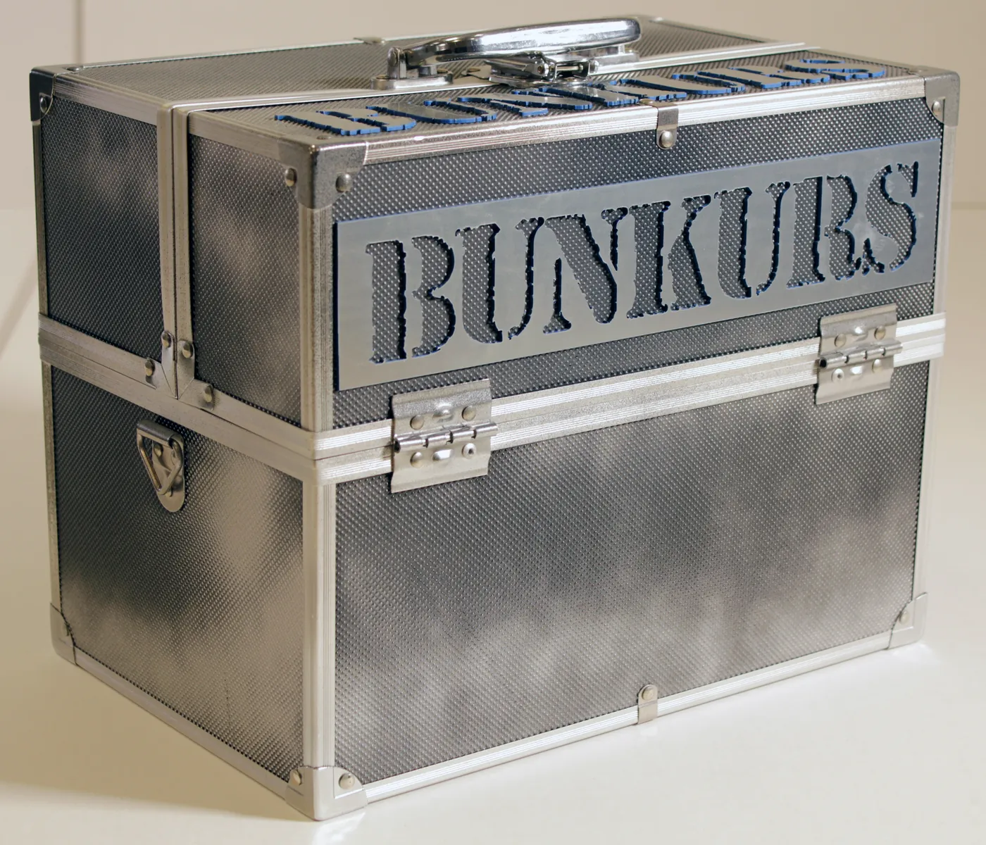 Metal-edged case with an industrial printed finish and a name cut out in large letters