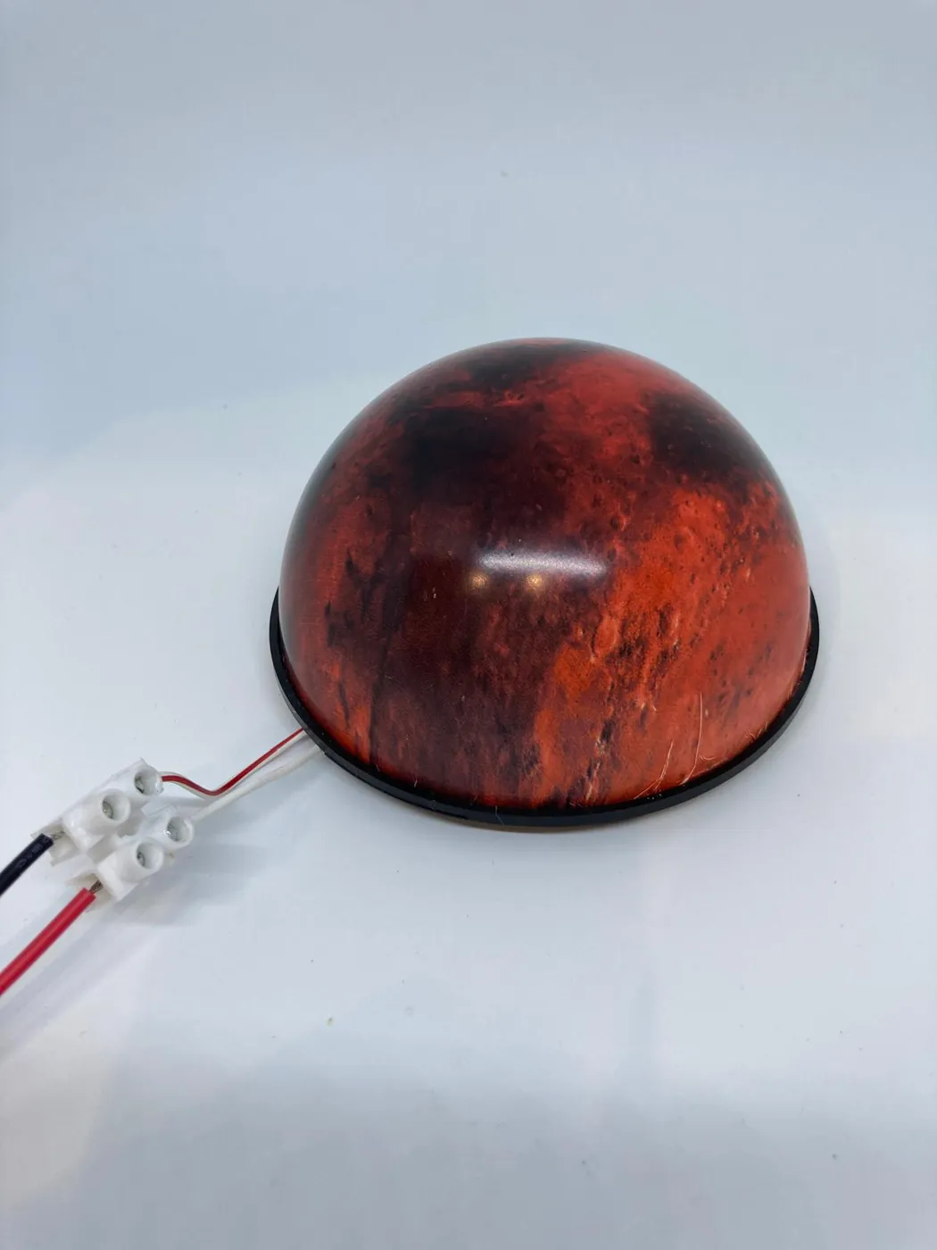Red Mars model on its black ring base, with the wires for the light inside