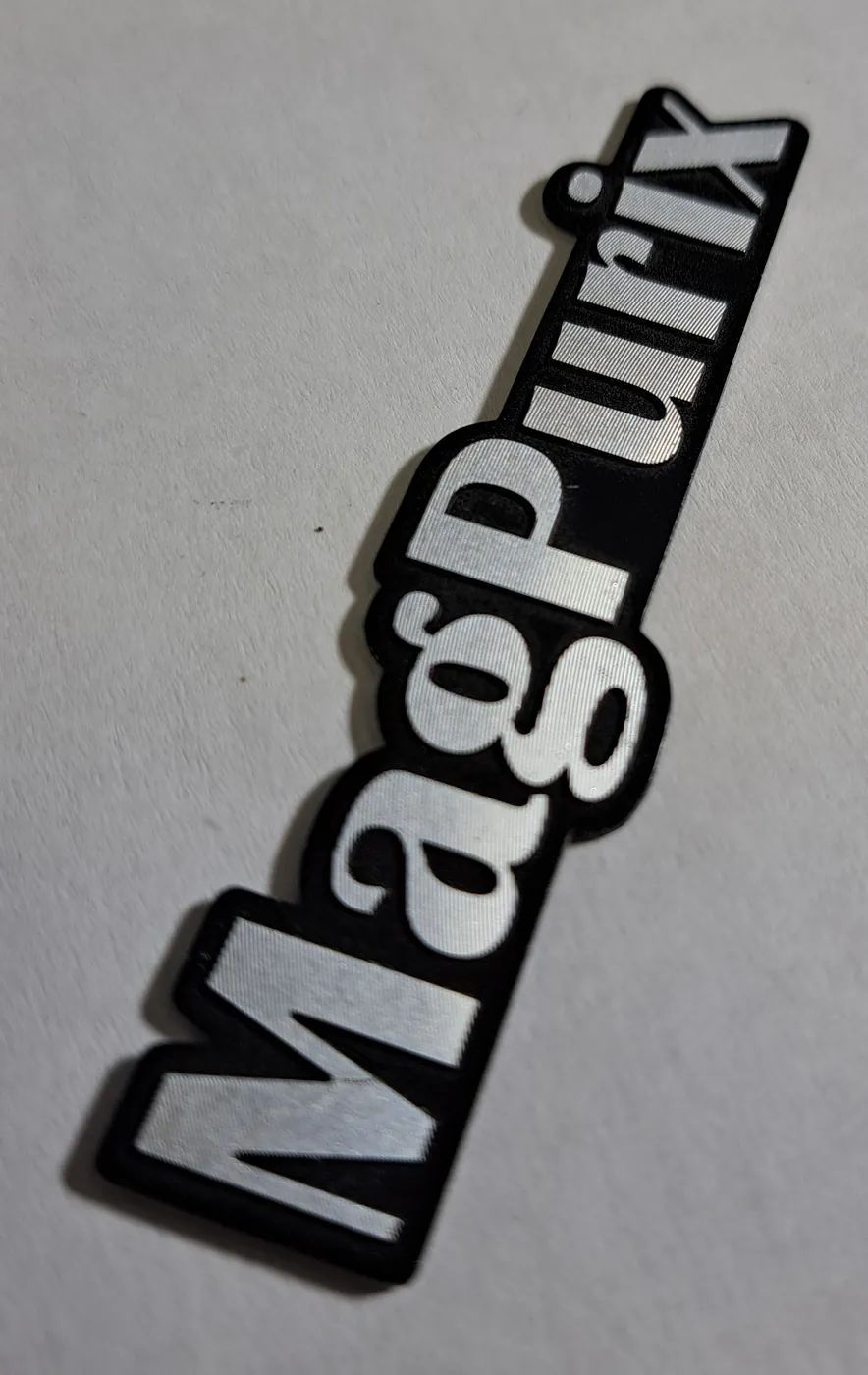 Black logo plaque with silver lettering, cut to the outline of the letters