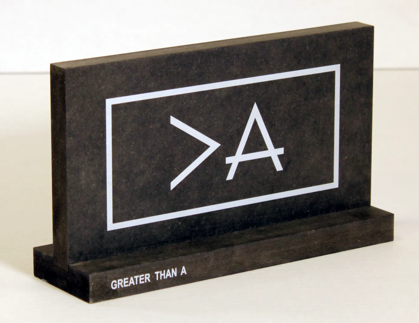 Dark tabletop sign standing in a matching base, with a white logo in a frame and lettering on the base